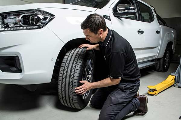 LDV technician inspecting a vehicle tyre